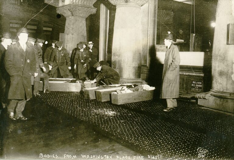 Photograph shows police or fire officials placing Triangle Shirtwaist Company fire victims in coffins.